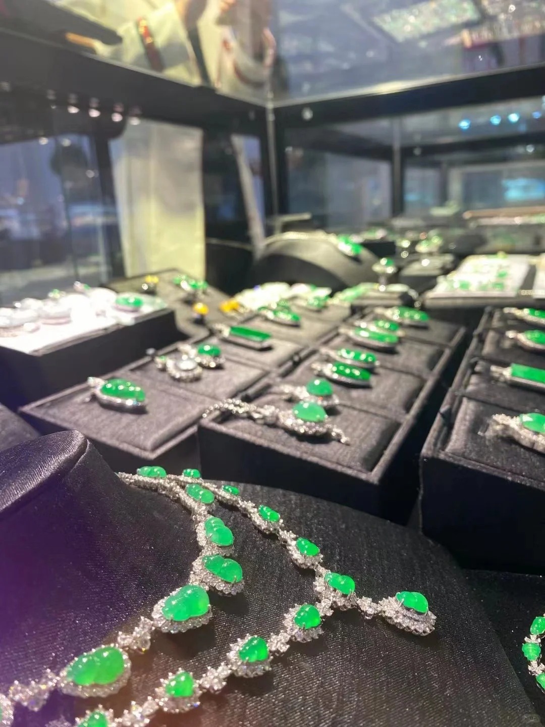 Emerald jewelry selection displayed in a GREER showroom
