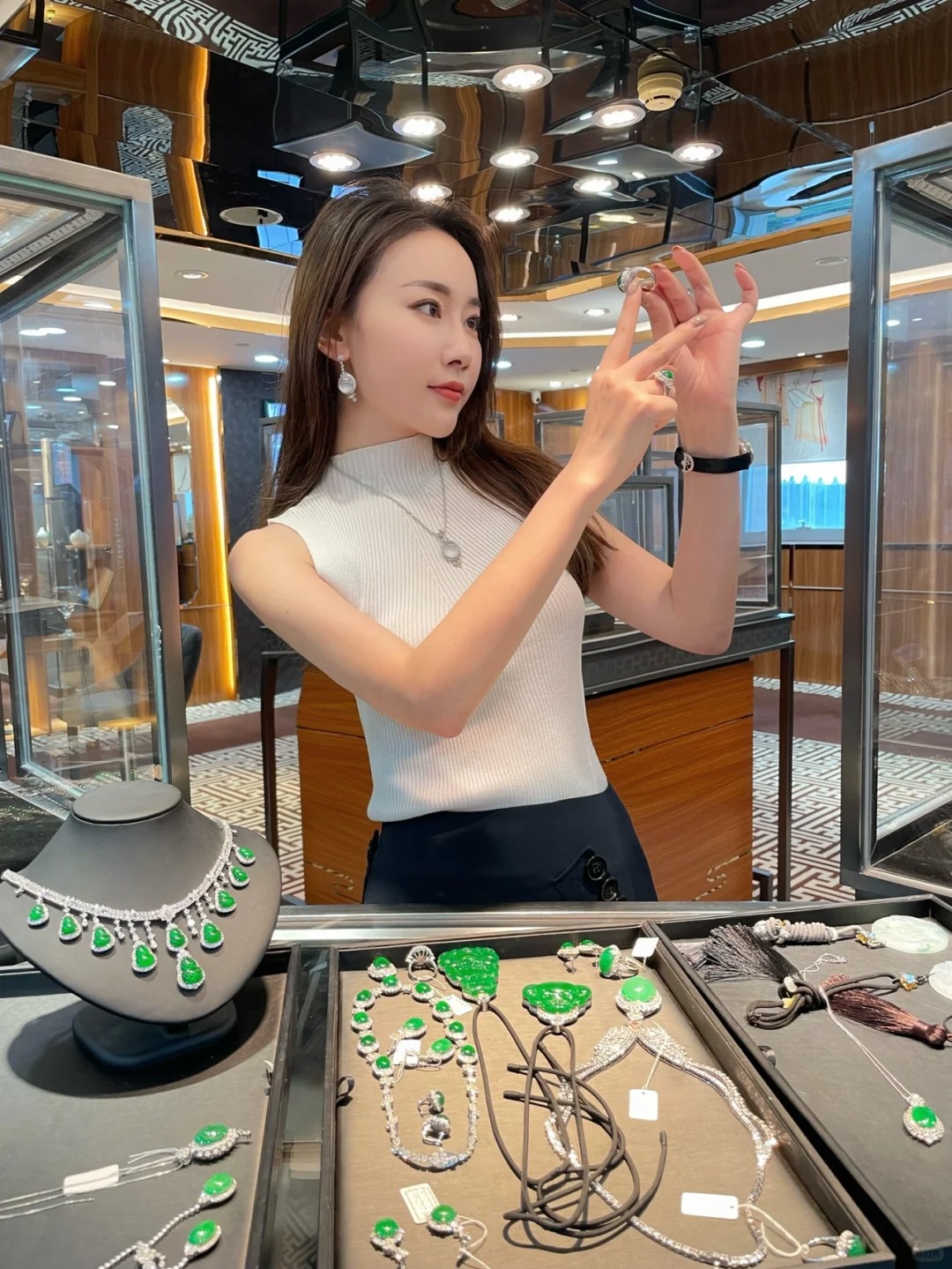 Jewelry consultant presenting jade pieces in store