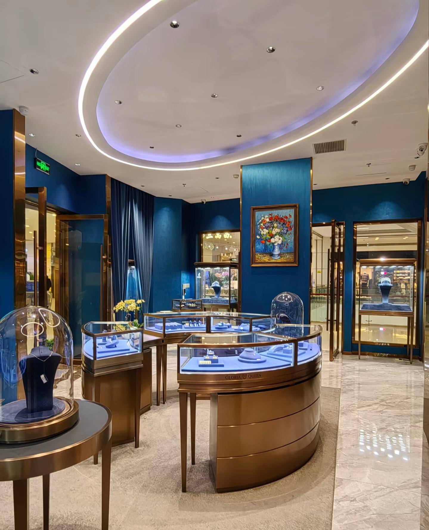 Luxury jewelry showroom with blue walls and bronze display counters